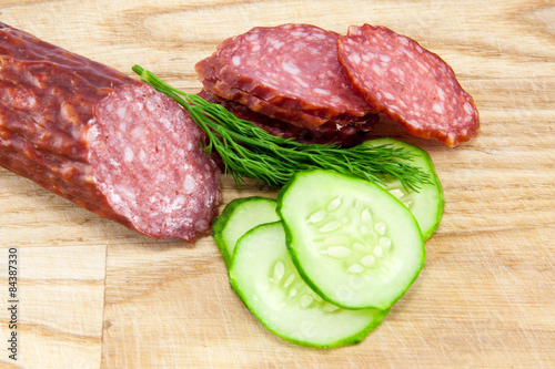 salami sausages on wooden board isolated