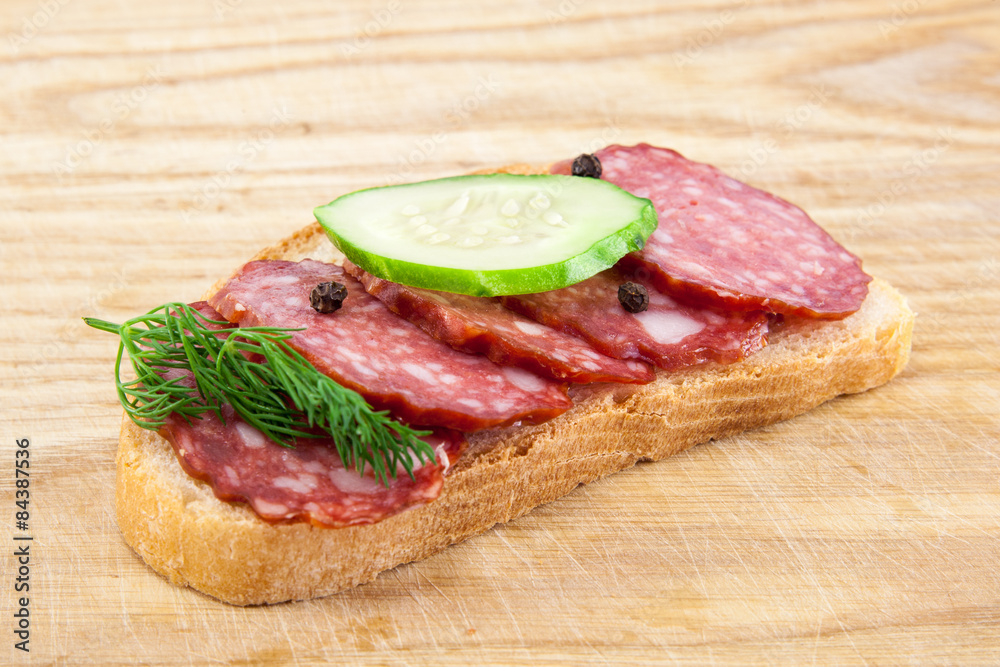 salami sausages on wooden board isolated