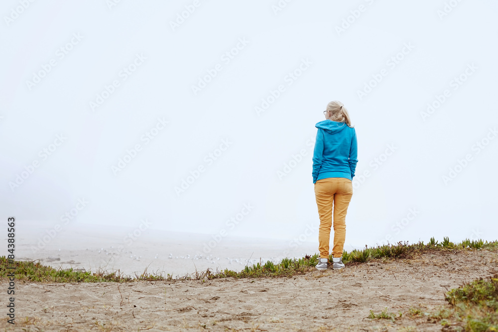 Girl on foggy beach