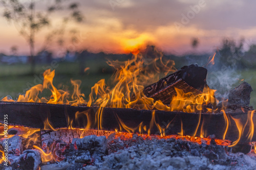 burning log in campfire, rural Ohio sunset