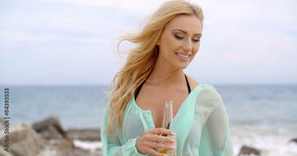 Blond Woman Holding Bottle of Beer on Beach Blond Woman Holding Bottle of Beer on Beach
