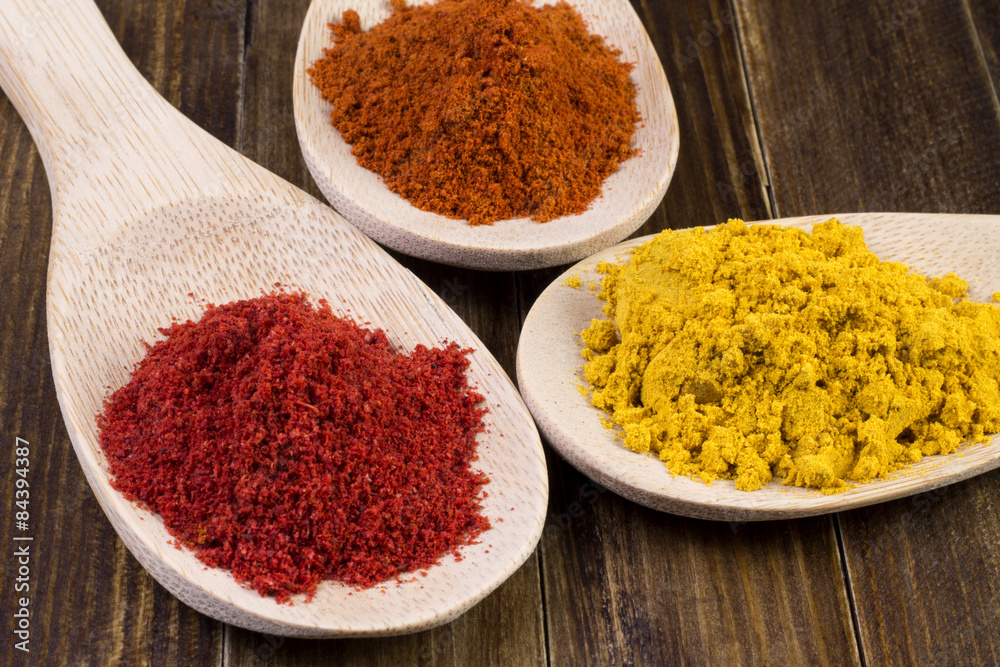 pepper and spices in a wooden spoon pepper and spices in a wooden spoon