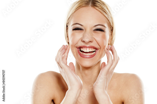 smiling and excited beautiful young woman on a white background