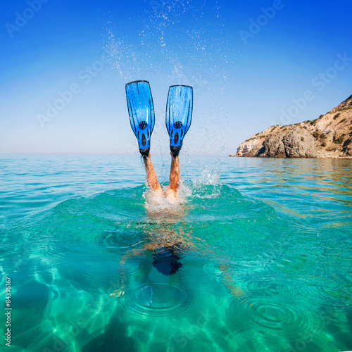 Diving. Women snorkeling in flippers beach islands. Girl dives photo