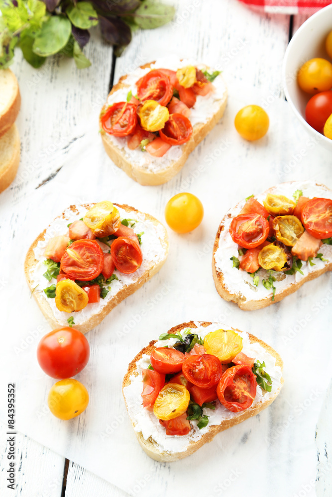 Tasty fresh bruschetta with tomatoes on white wooden background Tasty fresh bruschetta with tomatoes on white wooden background