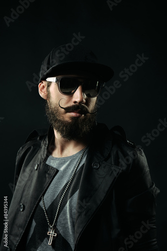 The bearded man with sunglasses looking away