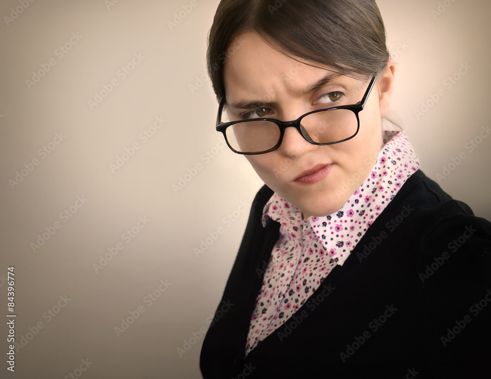 Young girl with a sour face suspiciously looking away Stock Photo | Adobe  Stock