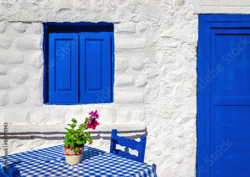 Iconic blue table with wooden chairs , Greece