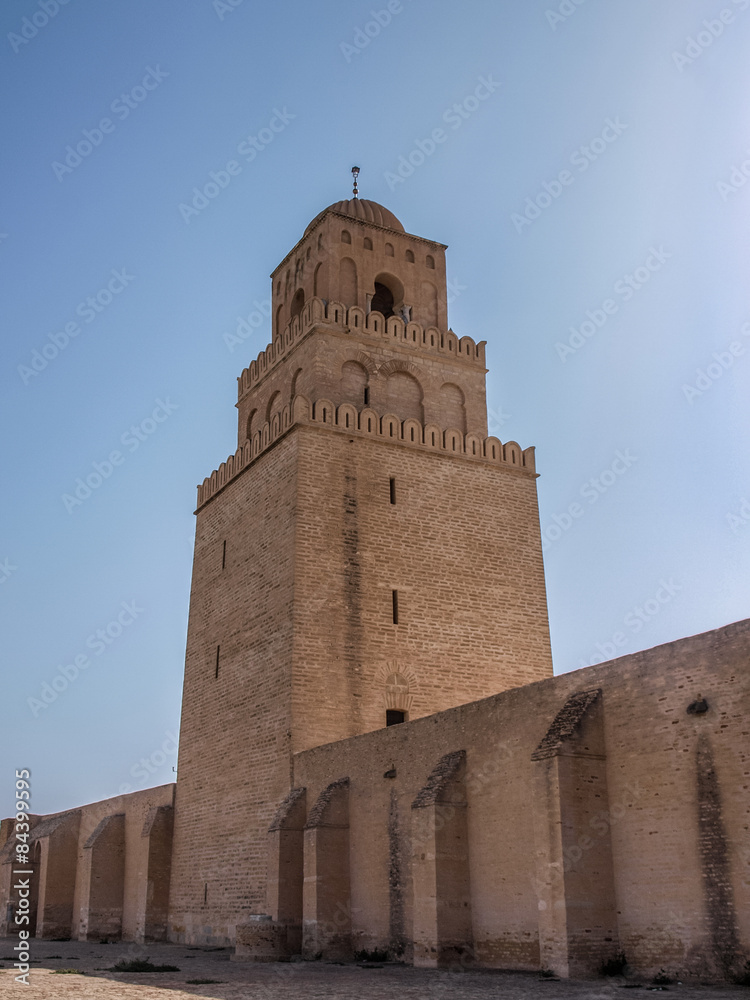 Tower of the Great Mosque in Kairouan against a blue sky