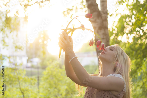 girl smelling a flower