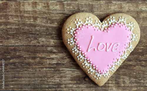 Gingerbread in the shape of heart with pink and white frosting