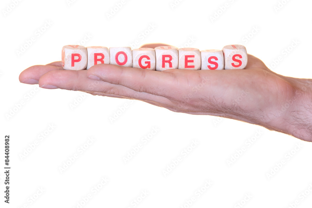 Progress written with wooden dice on a isolated hand