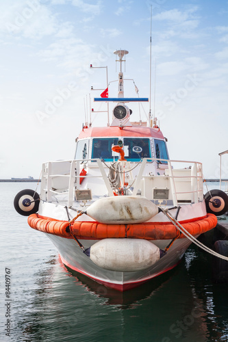 Red and white fire boat stands moored in Izmir