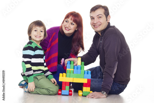 Father, mother and son playing Bricks