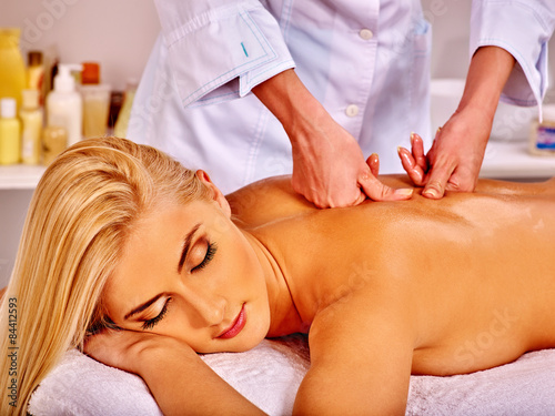 Woman getting facial massage .