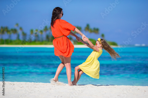 Little girl and young mother during beach vacation