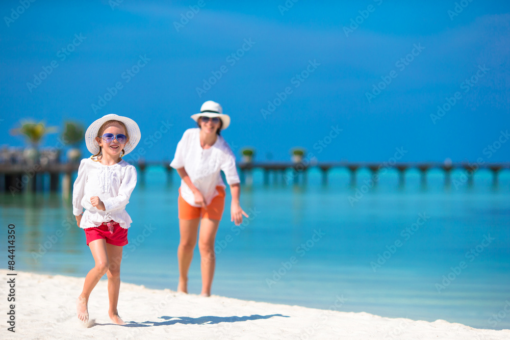 Little happy girl and young mother during beach vacation Little happy girl and young mother during beach vacation
