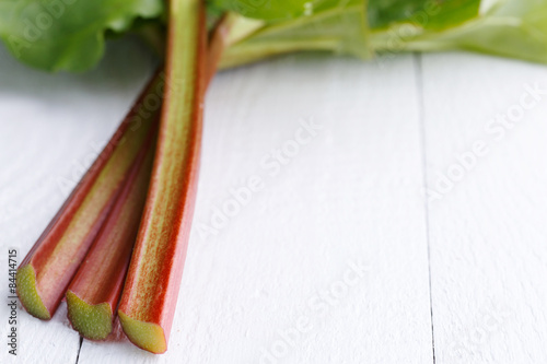 Rhubarb on white wooden table.