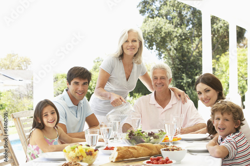 Three Generation Family Enjoying Meal Outdoors