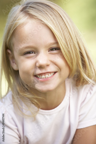 Portrait Of Young Girl Outside In Park