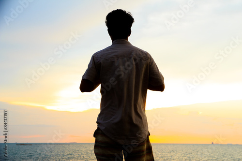 Stock Photo - silhouette of single man action at sunset.