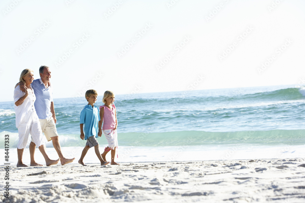 Grandparents and Grandchildren Walking Along Beach Grandparents and Grandchildren Walking Along Beach