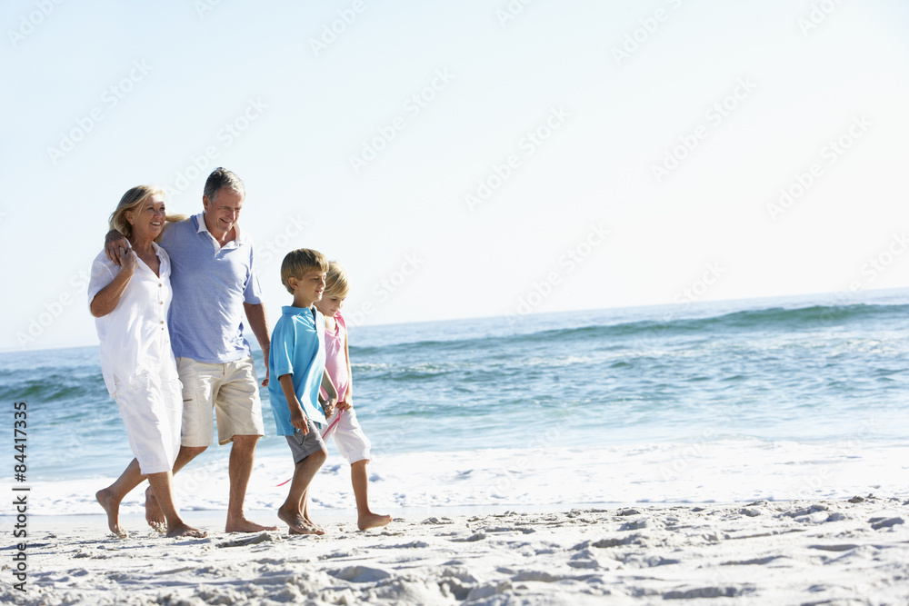 Grandparents and Grandchildren Walking Along Beach