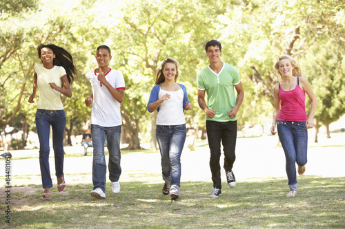 Group Of Teenage Friends Running In Park © Monkey Business