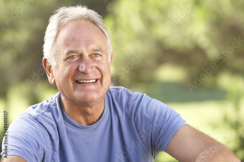 Portrait Of Senior Man Relaxing In Countryside