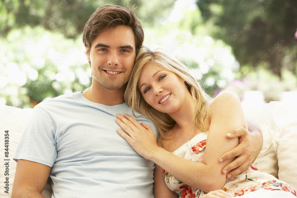 Portrait Of Young Couple Relaxing On Sofa