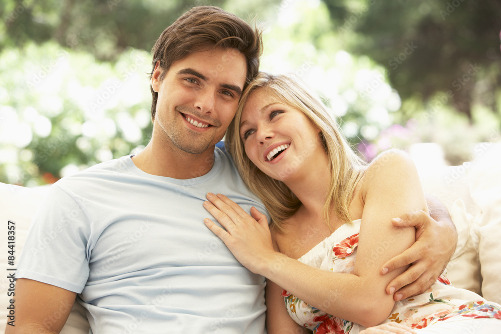 Portrait Of Young Couple Relaxing On Sofa Portrait Of Young Couple Relaxing On Sofa