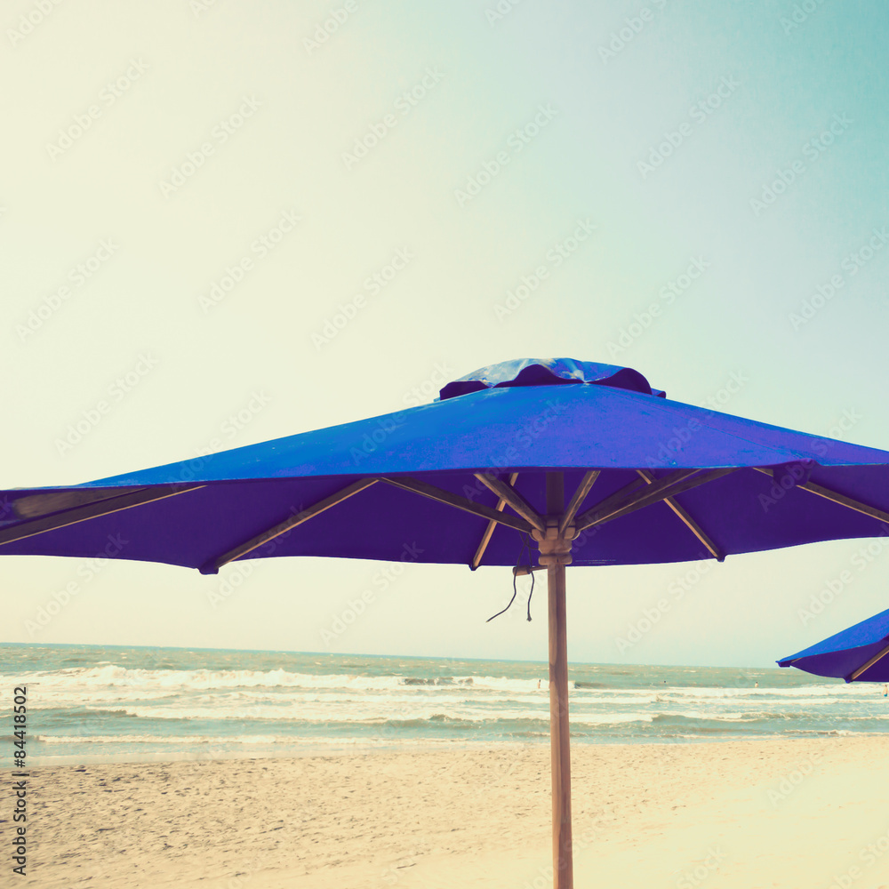 Retro beach with blue umbrella
