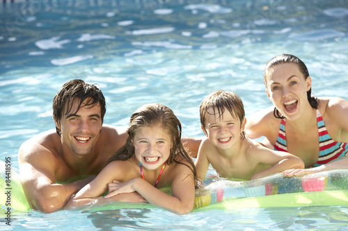 Young Family Relaxing In Swimming Pool © Monkey Business