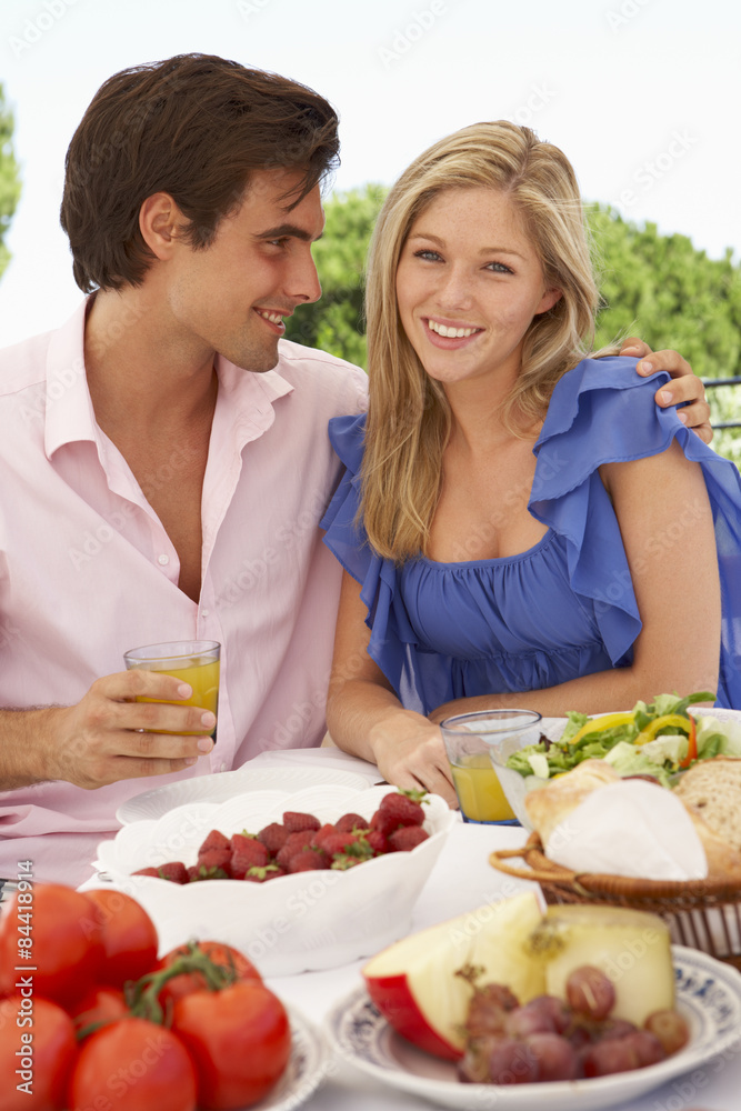 Young Couple Enjoying Outdoor Meal Together Young Couple Enjoying Outdoor Meal Together