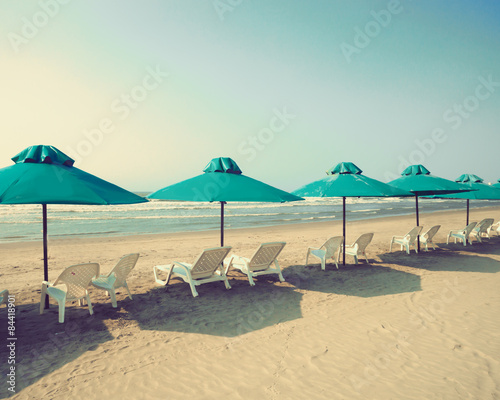 Retro beach with green umbrellas