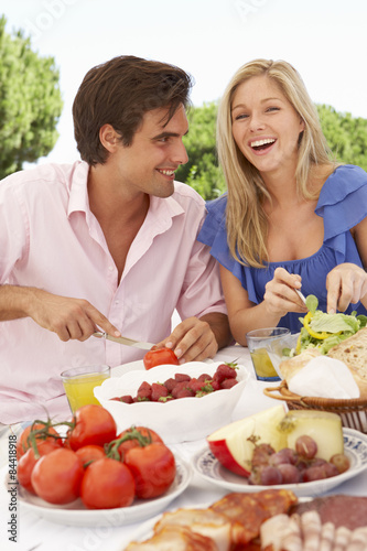 Young Couple Enjoying Outdoor Meal Together
