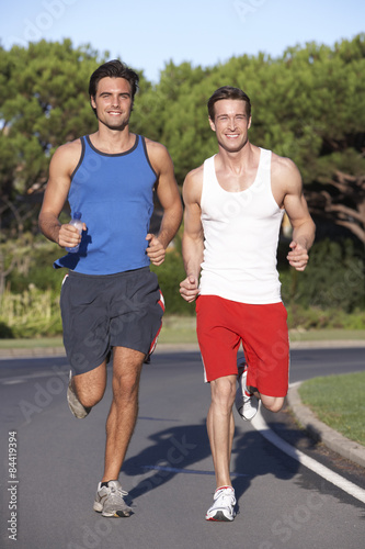 Two Men Running On Road