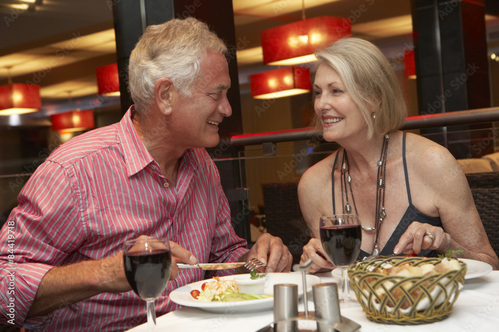 Senior Couple Enjoying Meal In Restaurant Senior Couple Enjoying Meal In Restaurant
