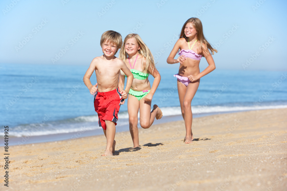 Children Running Along Summer Beach