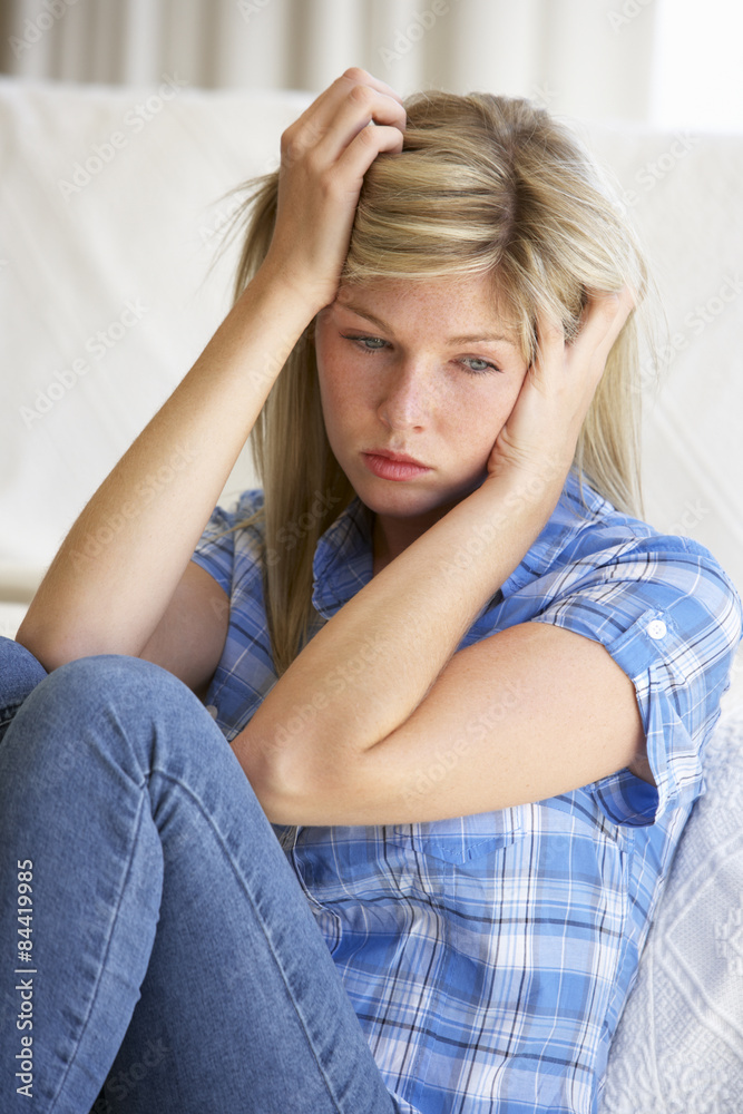 Portrait Of Depressed Young Woman At Home Portrait Of Depressed Young Woman At Home