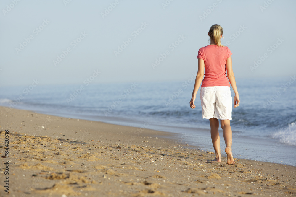 Woman Walking Along Beach
