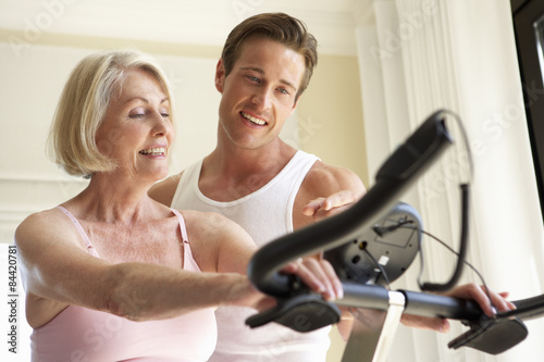 Senior Woman On Exercise Bike With Trainer