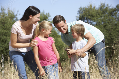 Young Family Walking Through Summer Countryside