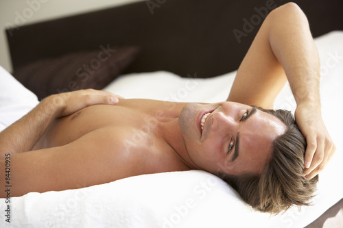 Young Man Relaxing On Bed