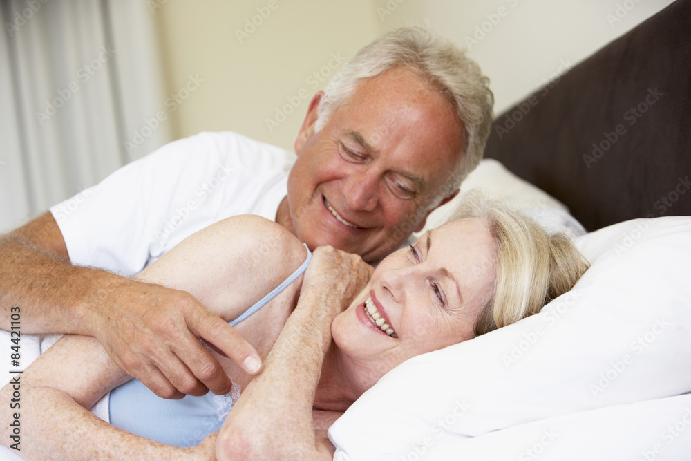 Senior Couple Relaxing On Bed Senior Couple Relaxing On Bed