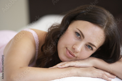 Young Woman Relaxing On Bed