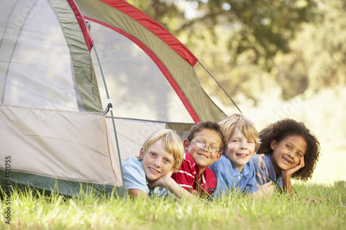 Group Of Boys Having Fun In Tent In Countryside