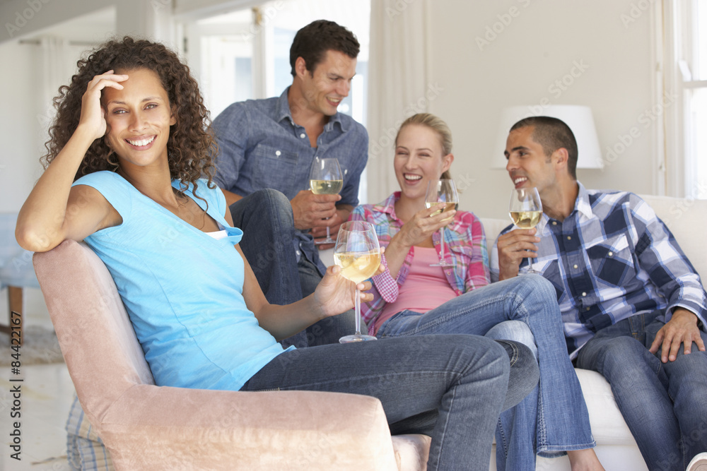 Group Of Friends Relaxing On Sofa Drinking Wine At Home Together Group Of Friends Relaxing On Sofa Drinking Wine At Home Together