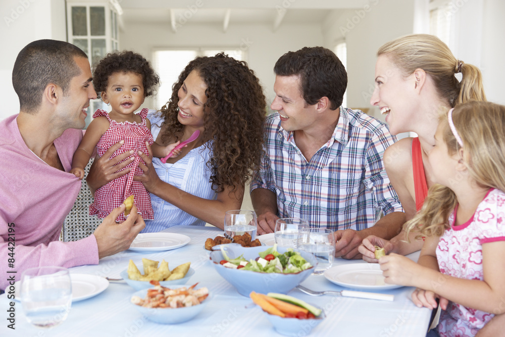 Families Enjoying Meal Together At Home Families Enjoying Meal Together At Home