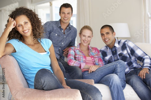 Group Of Friends Relaxing On Sofa At Home Together